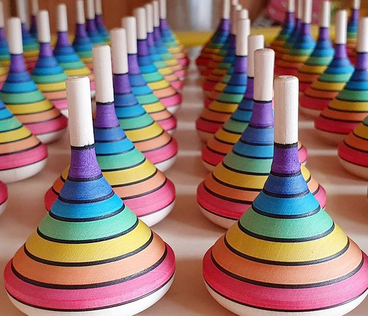 Wooden Spinning top hand painted with rainbow stripes