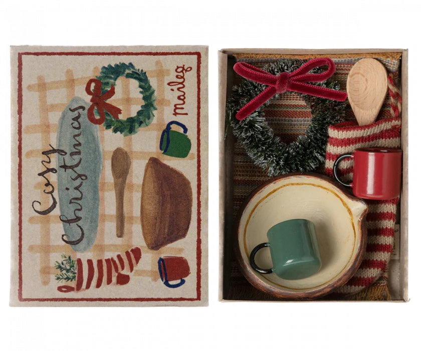 gift box with festive wreath, stocking, cups, rug, bowl and a wooden spoon