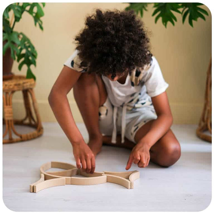 A child playing with Abel Blocks Mini 12 REWOOD