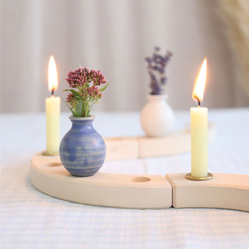 Blue vase placed on celebration ring with candles