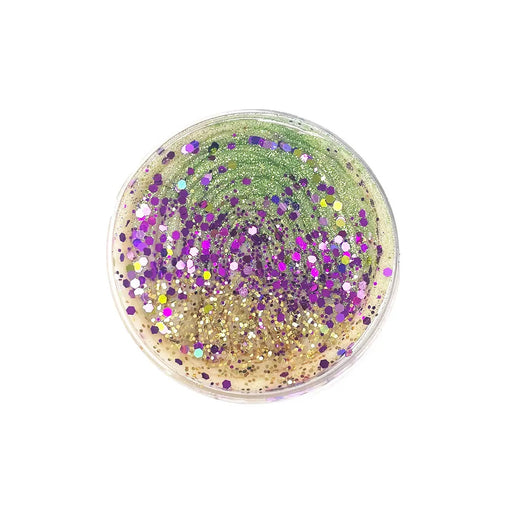 Play dough in a clear container with beautiful green, gold and purple glitter on top with a tiny baby figurine to hide inside