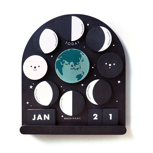 Black Wooden Moon phase calendar with magnetic moon phase discs on a white background 