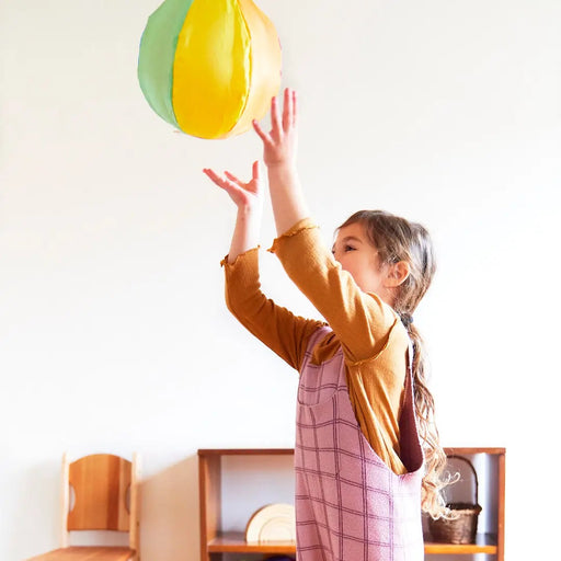 A child playing with Rainbow Balloon Ball 