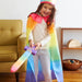 Child playing with Soft Sword dressed in Rainbow cape and Crown