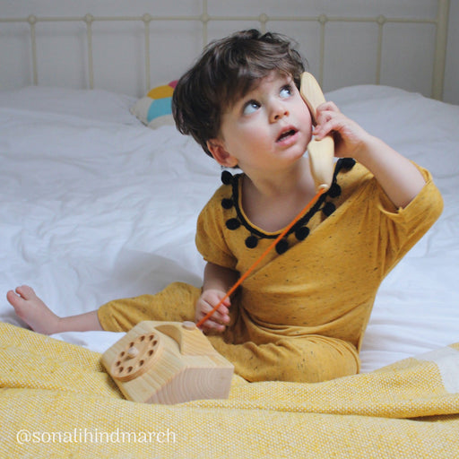 A child playing with the Telephone 