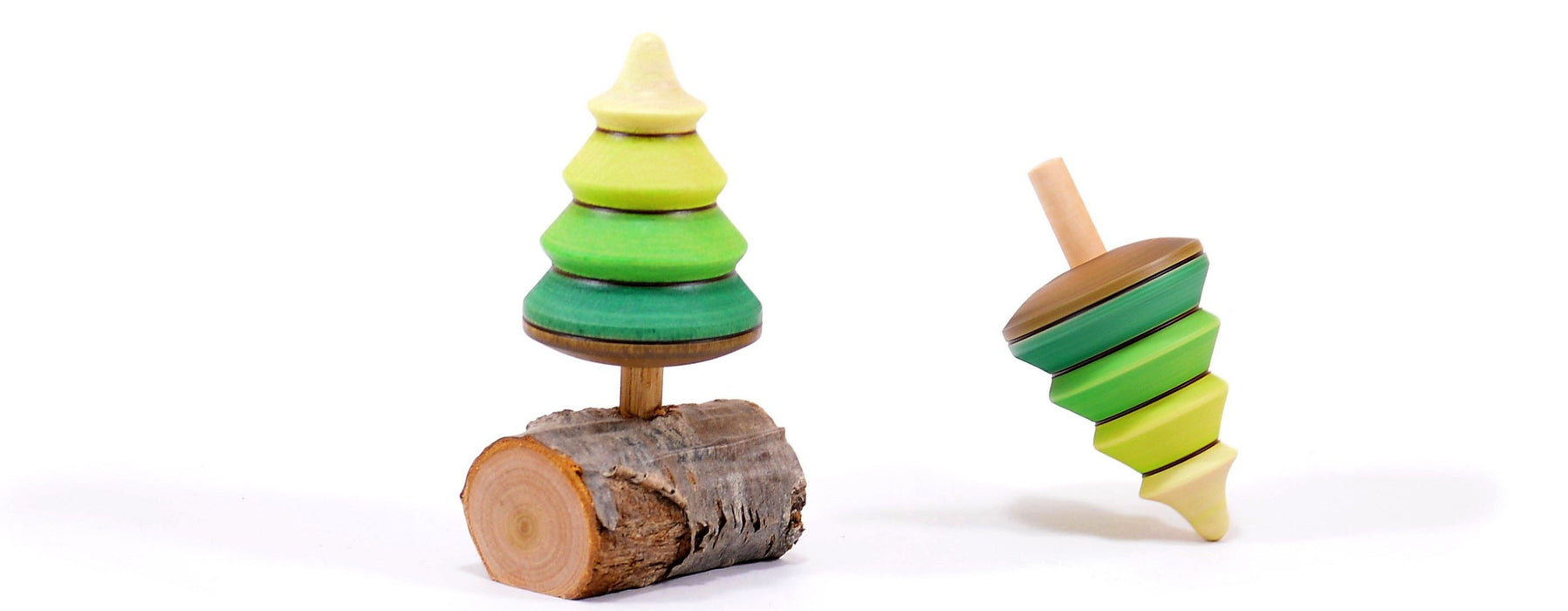 wooden top in the shape of a pine tree one on a brach base and one spinning on its top